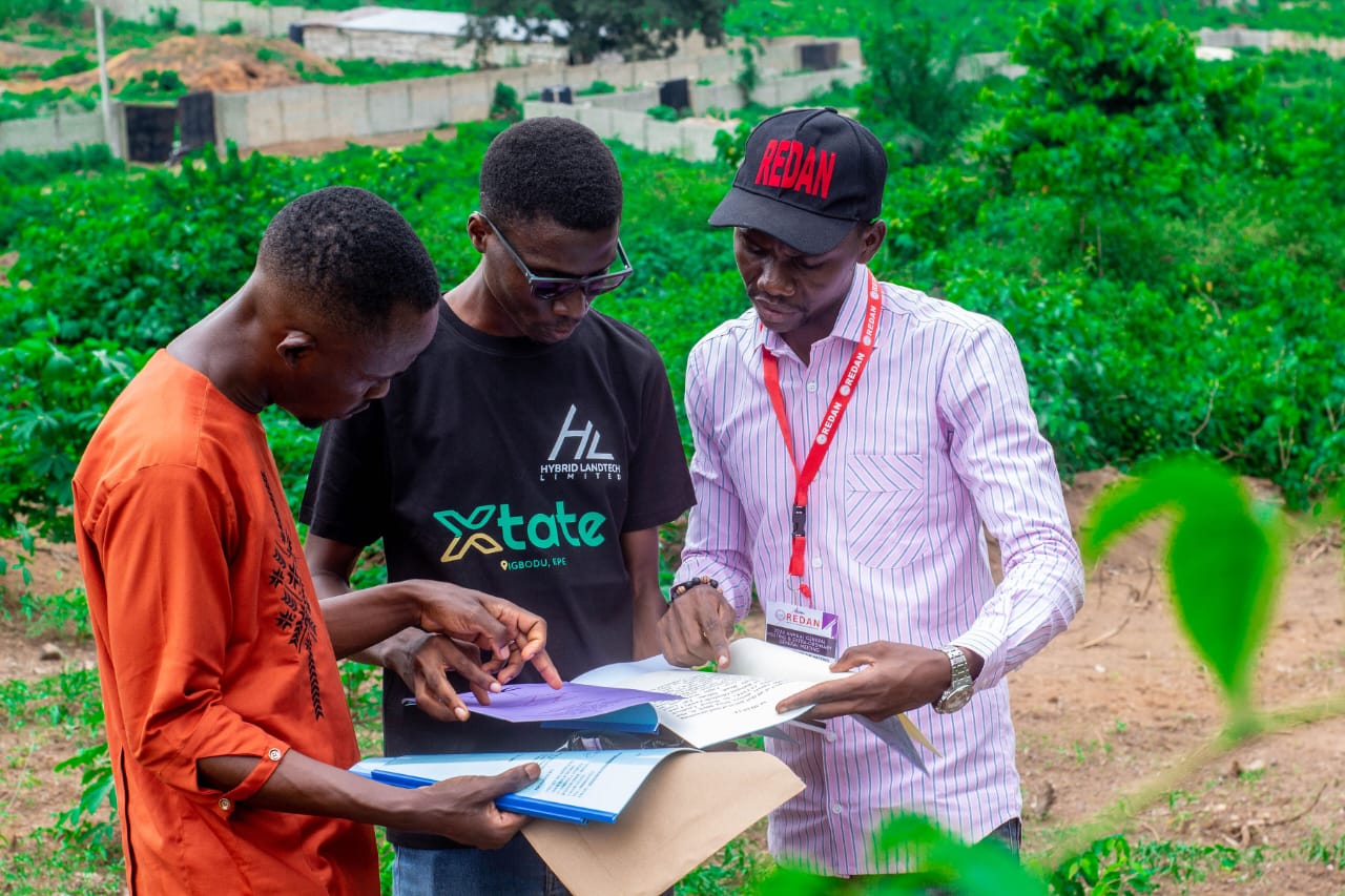 Client, sales rep and developer going through the contractual agreement in a land purchase documentation
